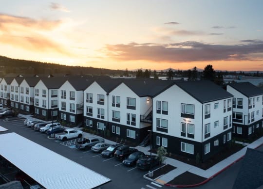 an aerial view of an apartment complex at sunset