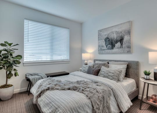 a bedroom with a bed and a painting of a cow