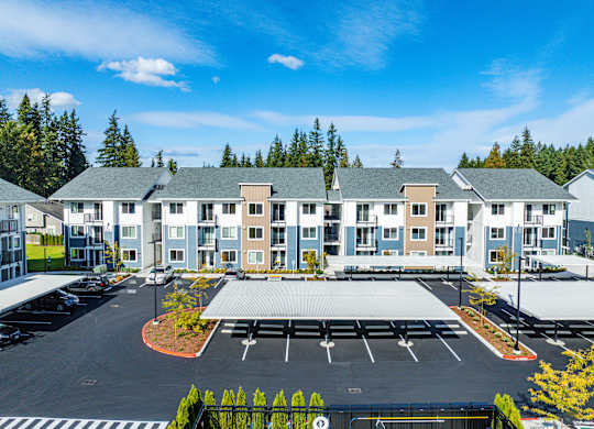 A large building with a parking lot in front of it.