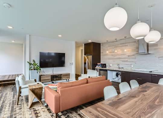 A modern living room with a wooden table and orange sofa.