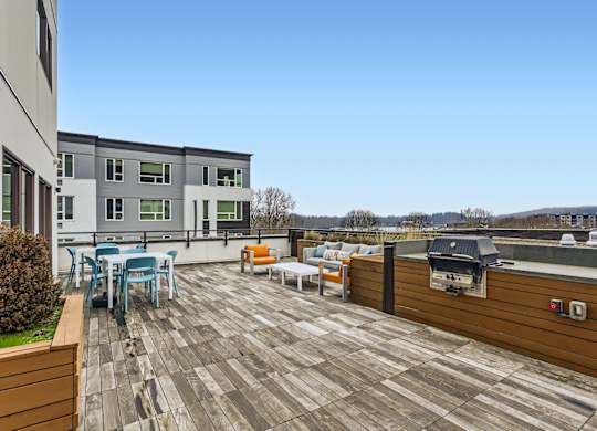 A patio with a table and chairs overlooking a city.