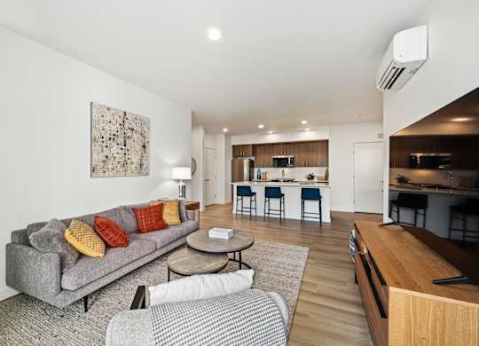 A modern living room with a grey couch and a coffee table.