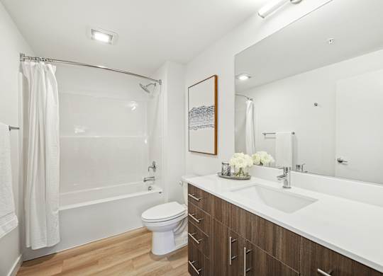 A white toilet sits next to a white sink in a bathroom.