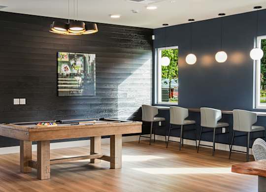 A dining room with a wooden table and chairs.