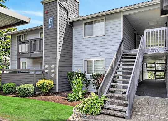 Apartment complex with a staircase leading to the second floor.