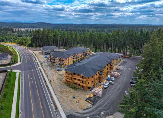 A road construction site with a large building under construction.