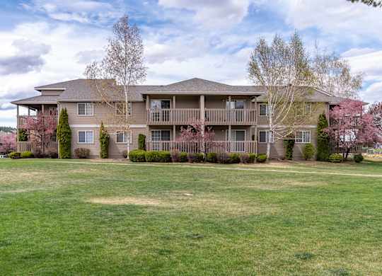 A large, multi-level home with a balcony and a deck.