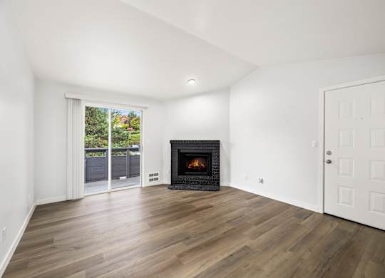 a living room with a fireplace and a door to a patio