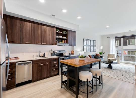 A modern kitchen with wooden cabinets and a dining table with four chairs.