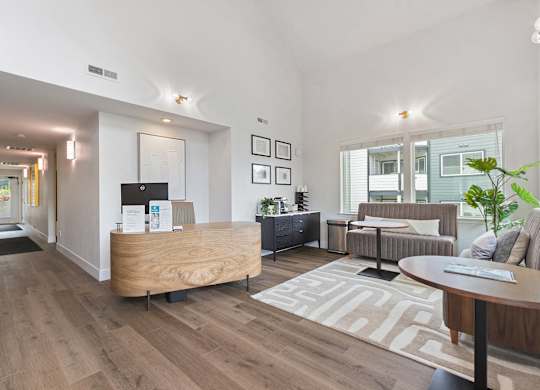 A modern living room with a wooden reception desk and a couch.