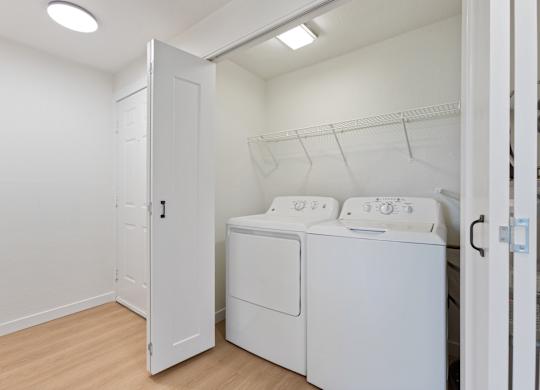 A white laundry room with a washer and dryer.