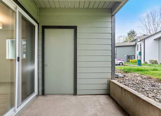 A grey door is closed with a black frame.
