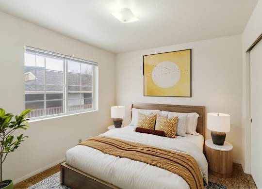 A bedroom with a large bed and a painting above it.