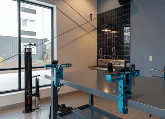 A workbench with a blue clamp and a black clamp.