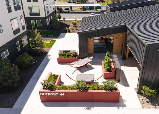 A modern building with a black roof and a sign that says