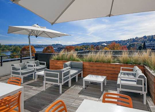 A patio with a table and chairs overlooking a river.