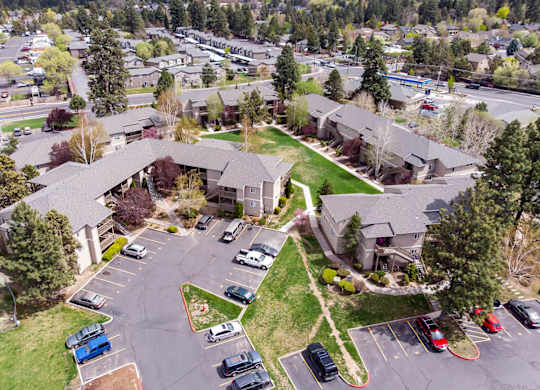 A parking lot with cars and a building in the background.
