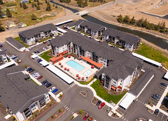 A bird's eye view of a residential complex with a swimming pool.