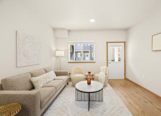 A living room with a couch, chair, and coffee table.