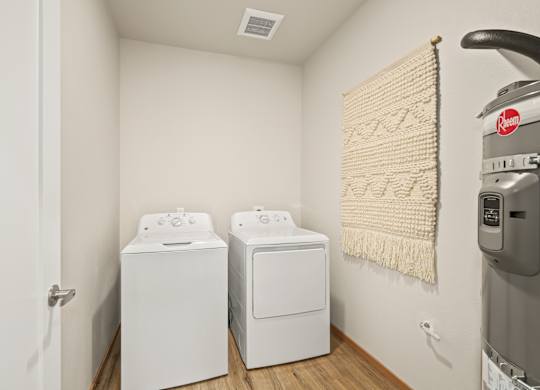 A laundry room with a washer and dryer and a washing machine.