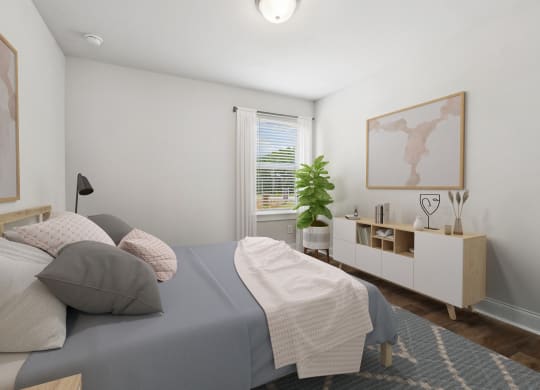 a bedroom with white walls and a bed with gray sheets and pillows