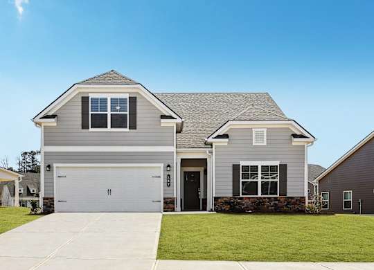 A two-story house with a garage and a driveway.