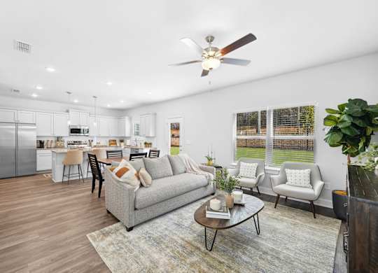 A modern living room with a grey couch and a coffee table.