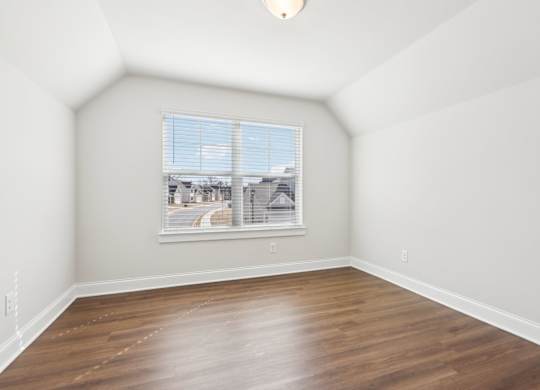Empty room with a window overlooking a street.
