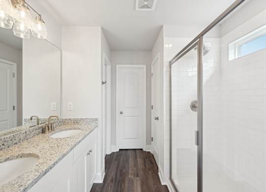 Primary Bathroom with double vanity and walk-in shower