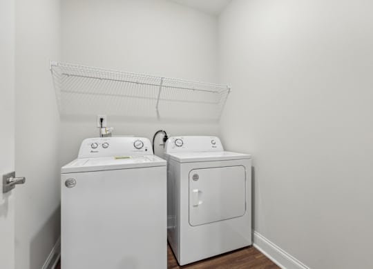 A white washing machine and dryer in a small laundry room.