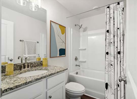 Secondary suite bathroom with a tub and shower combination