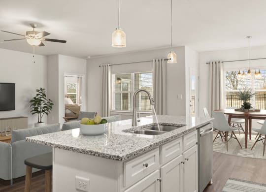 an open kitchen and living room with an island and a sink