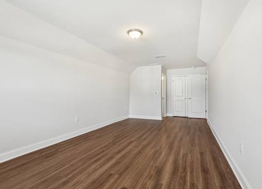 A room with wooden floors and white walls.