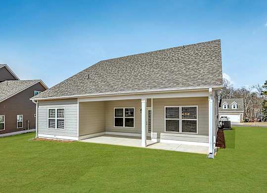A house with a grey roof and a brown door.