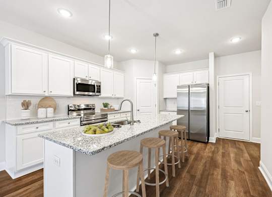 A view of the spacious kitchen and stainless steel appliances