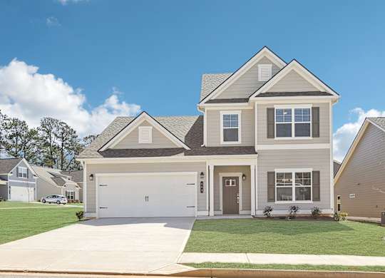 A two-story house with a garage is shown in the image.
