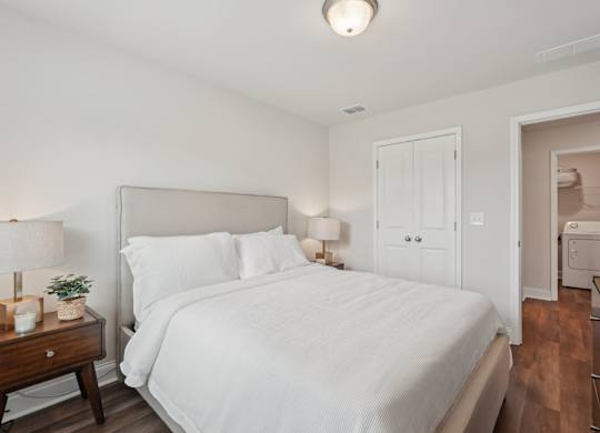 Secondary bedroom with queen size bed and large window letting in a ton of natural light.