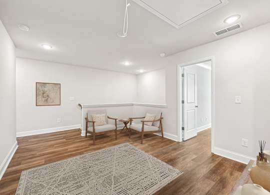 Cozy upstairs loft featuring two stylish chairs—perfect for relaxing or unwinding with a good book.