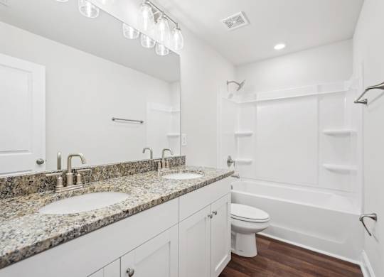 Secondary bathroom with tub shower and double vanity.