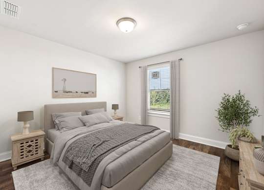 Secondary bedroom with queen size bed and large window letting in a ton of natural light.