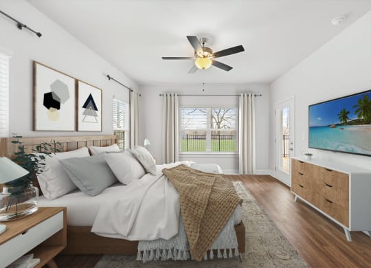 a bedroom with a large bed and a ceiling fan