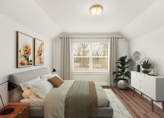 a bedroom with a bed and a large window