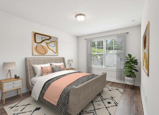 Secondary bedroom with queen size bed and large window letting in a ton of natural light.