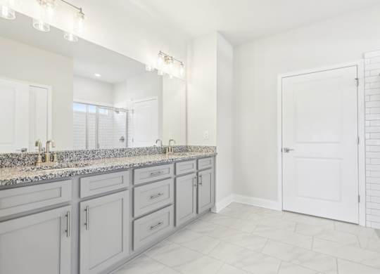 A bathroom with a vanity and a walk-in shower.