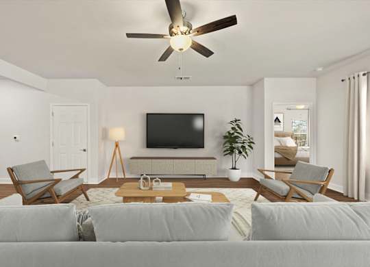 A living room with a grey couch and a wooden coffee table.