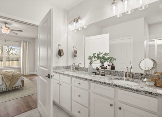 a bathroom with white cabinets and a sink and a mirror