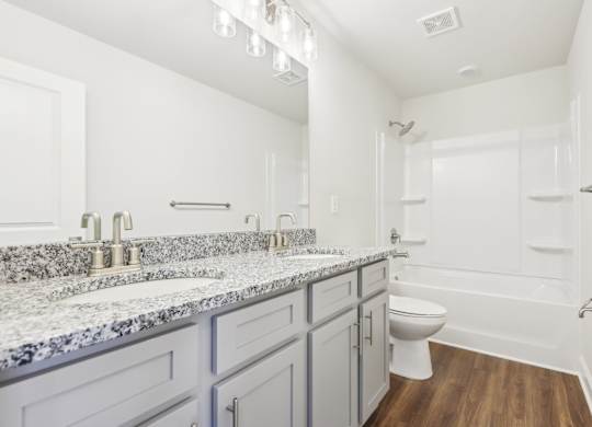 A bathroom with a toilet, sink, and bathtub.