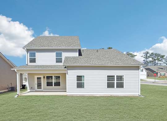 A two-story house with a grey roof and white siding.