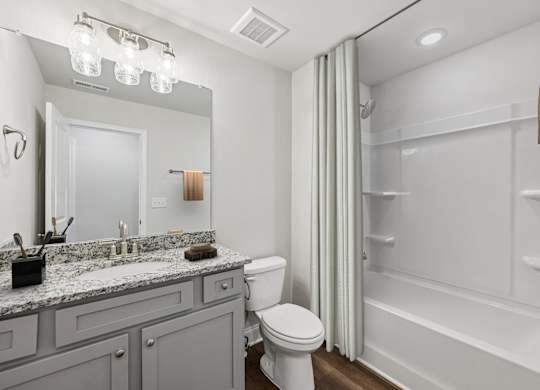 Secondary suite bathroom with a tub and shower combination