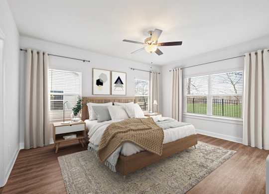 A bedroom with a large bed and a ceiling fan.